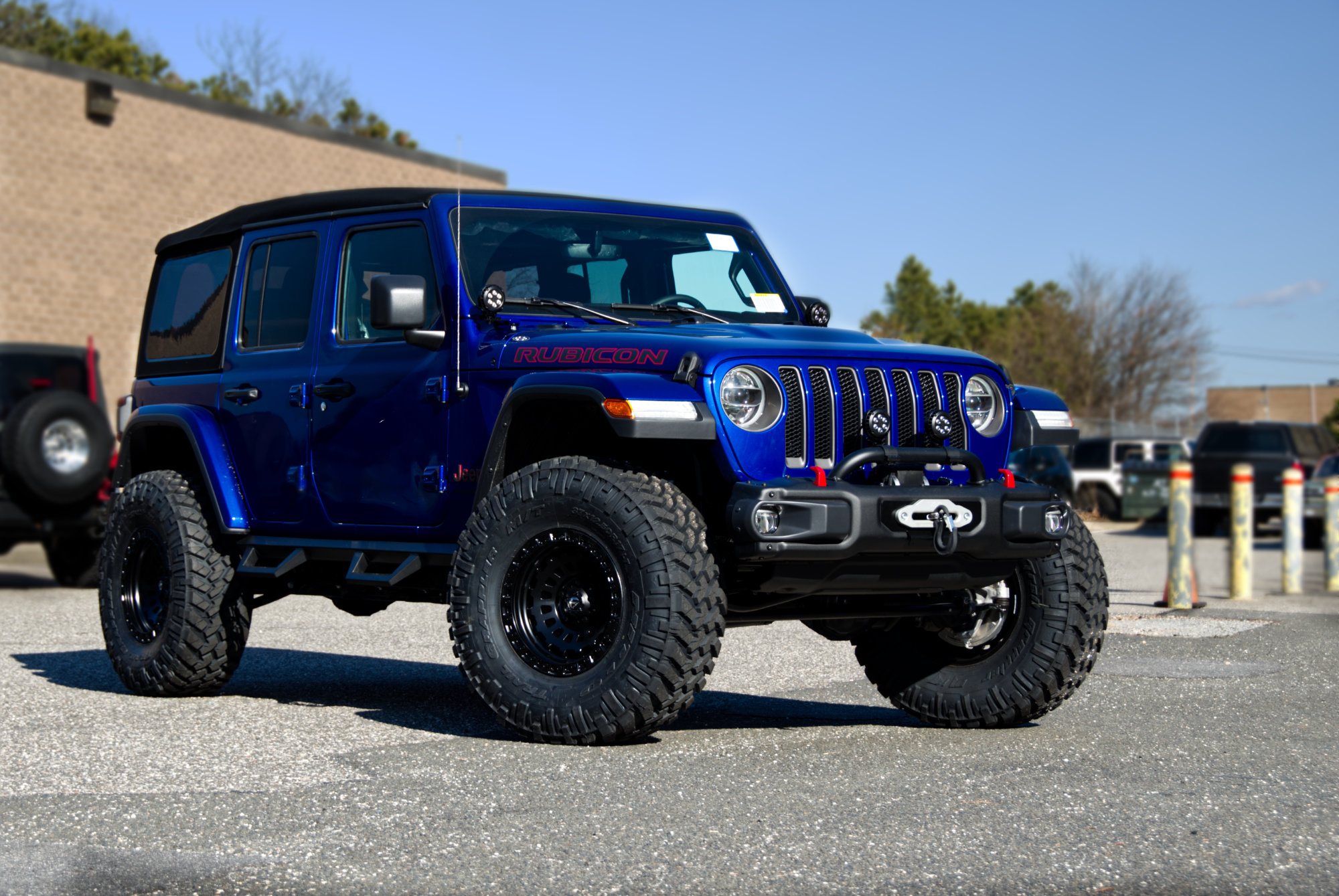 lifted Blue Jeep Wrangler with Fuel Wheels