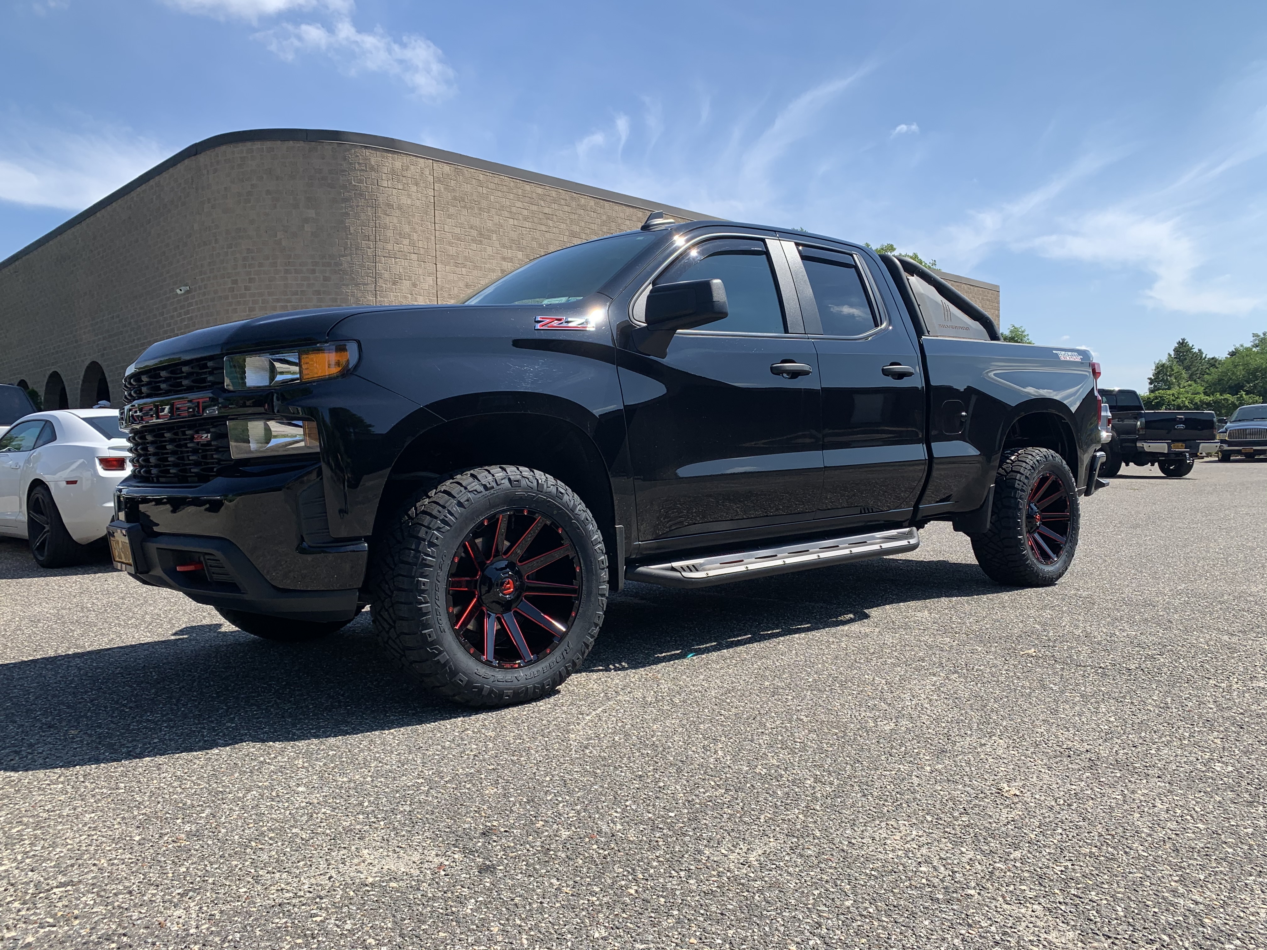Black Chevrolet Silverado lifted with wheels and tires