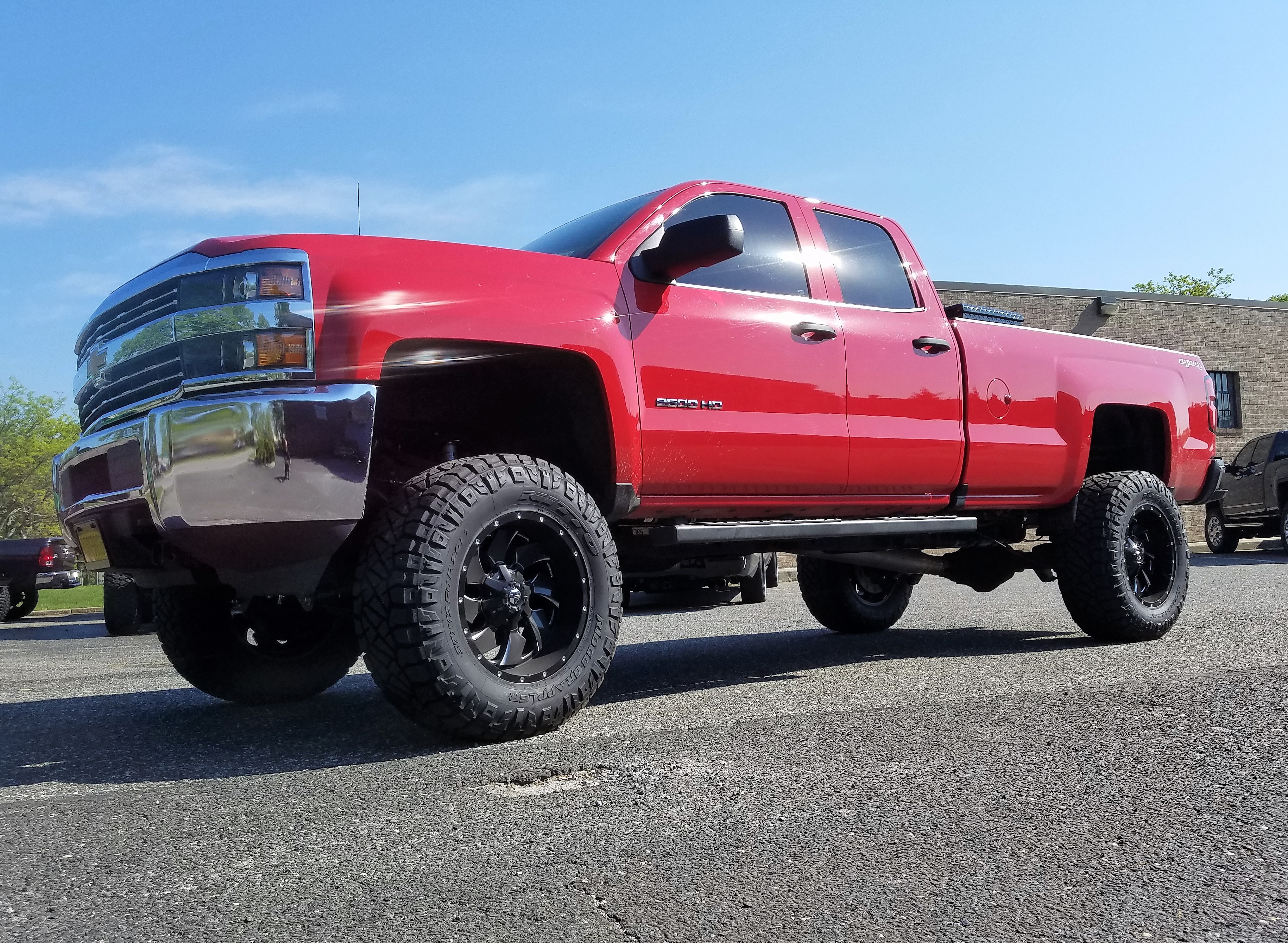 Red GMC Sierra lifted with wheels and tires