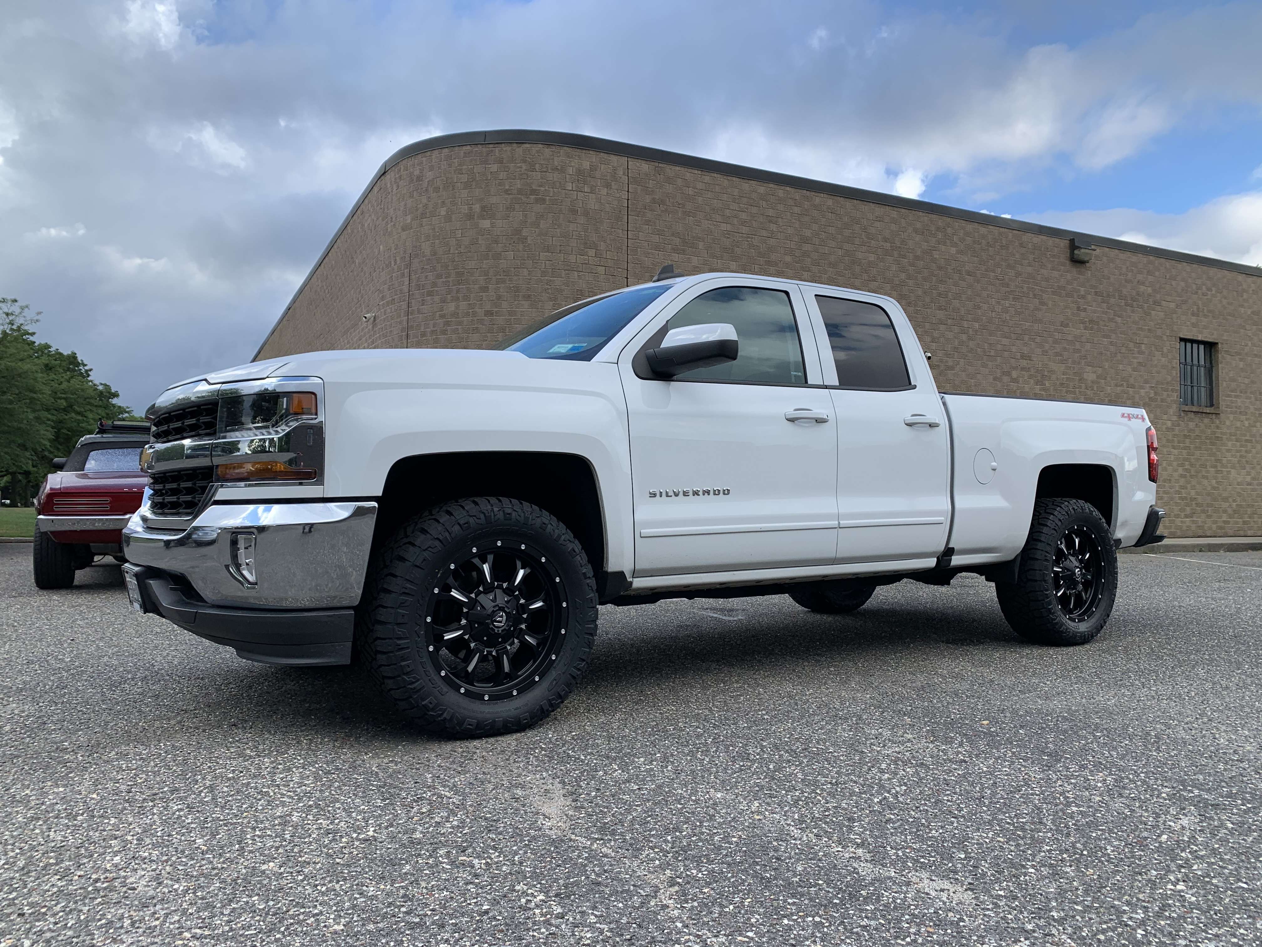 White Chevrolet Silverado,
                             lifted with tires and wheels